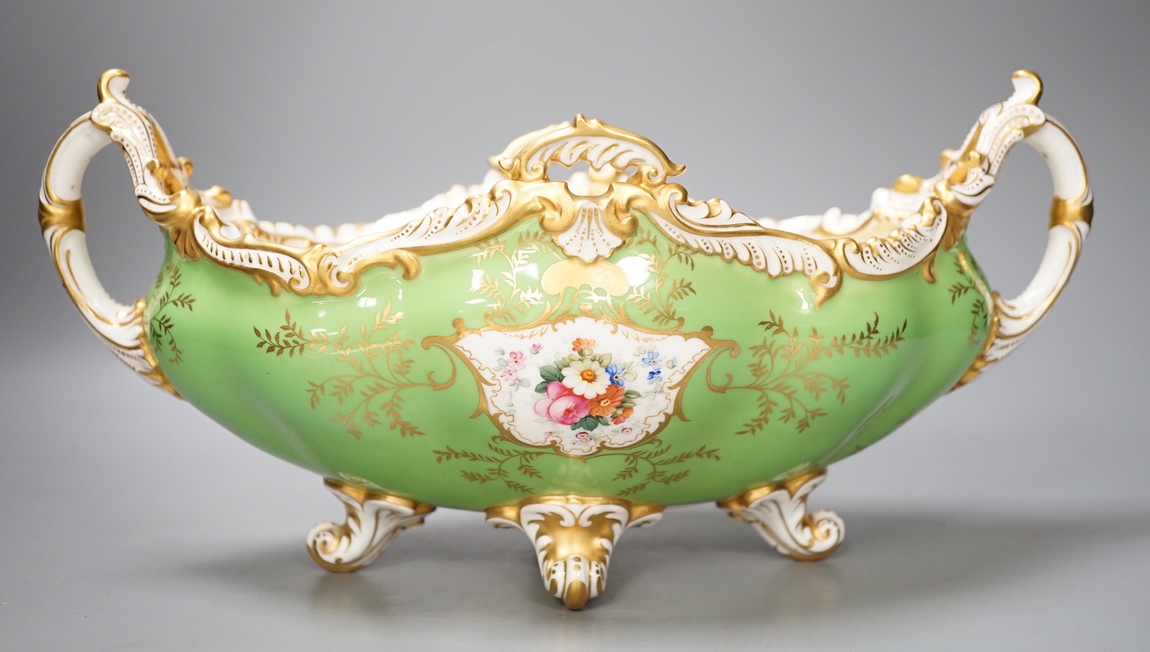 A Coalport twin handled boat shaped vase painted with a bird in panel on a lime green ground, c. 1900, 33cm